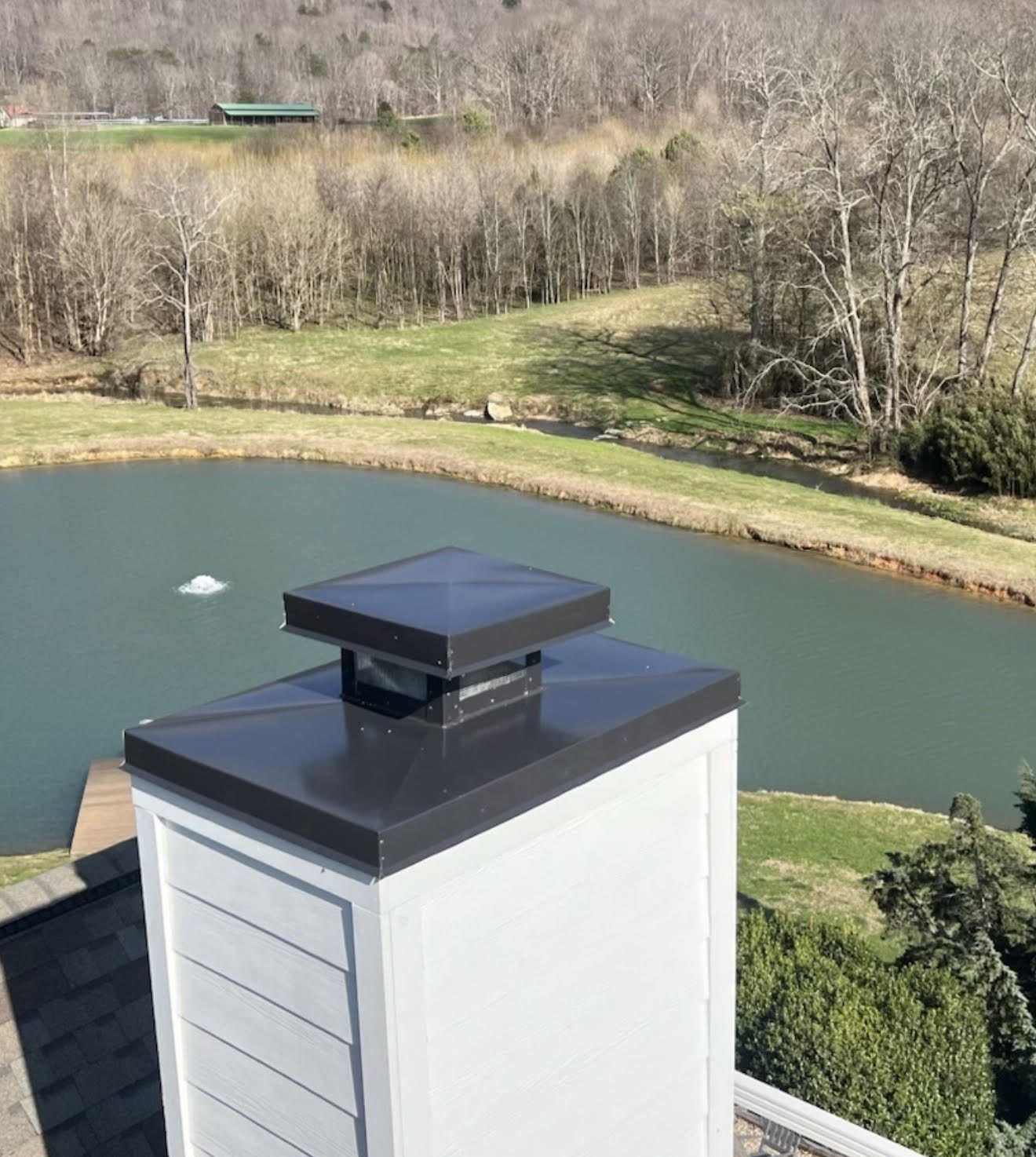 New chimney flashing and metal roof above the Tennessee River